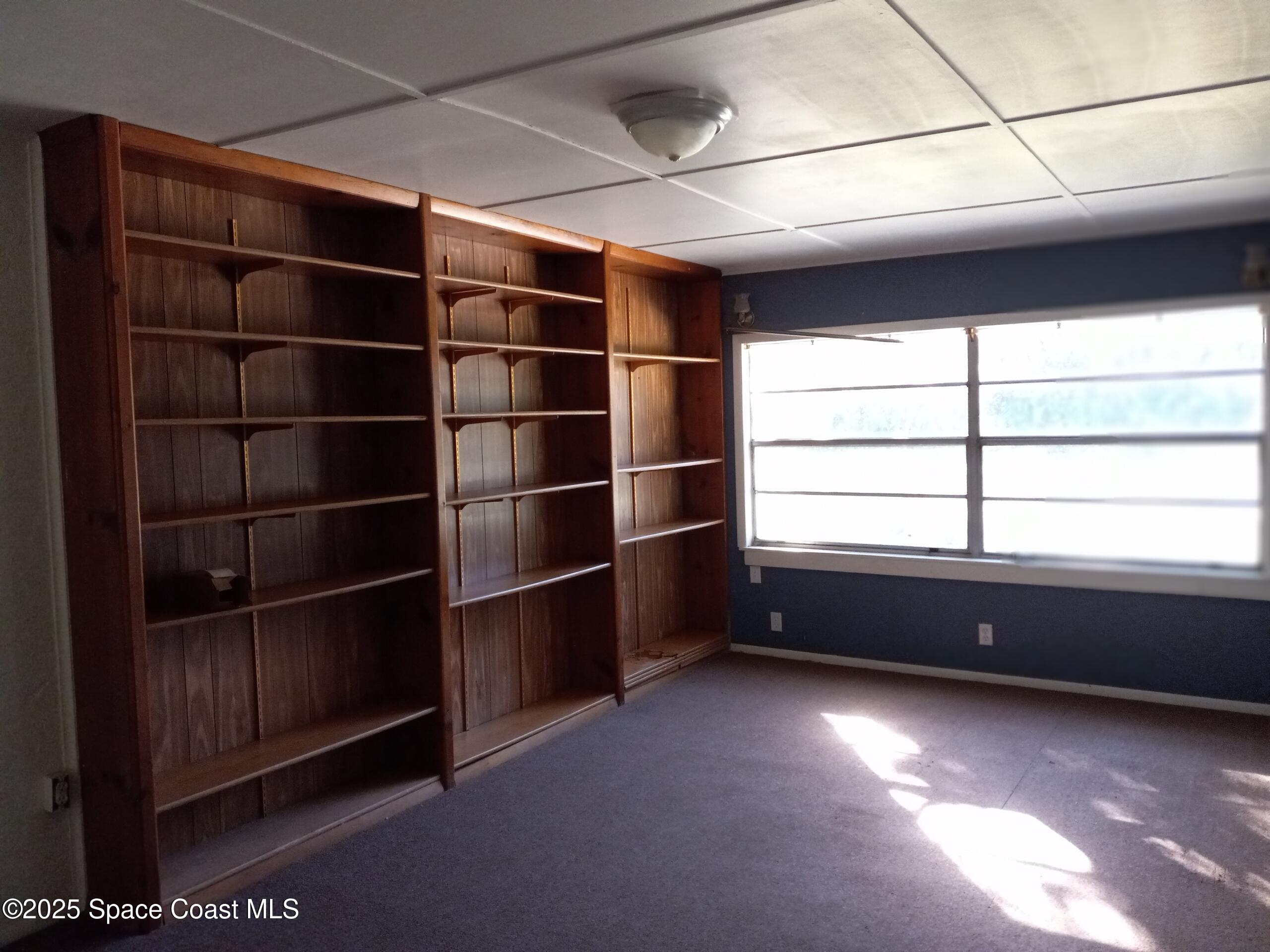 4335 Kumquat Street Cocoa, FL 32926 - Photo 8 of 21 a room with furniture and a window