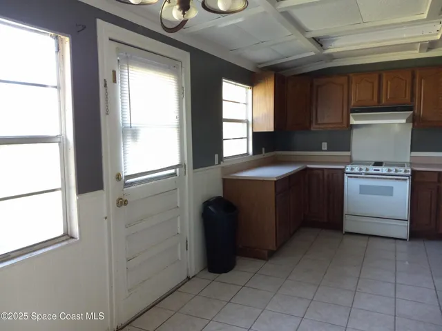 a kitchen with a sink a stove and cabinets