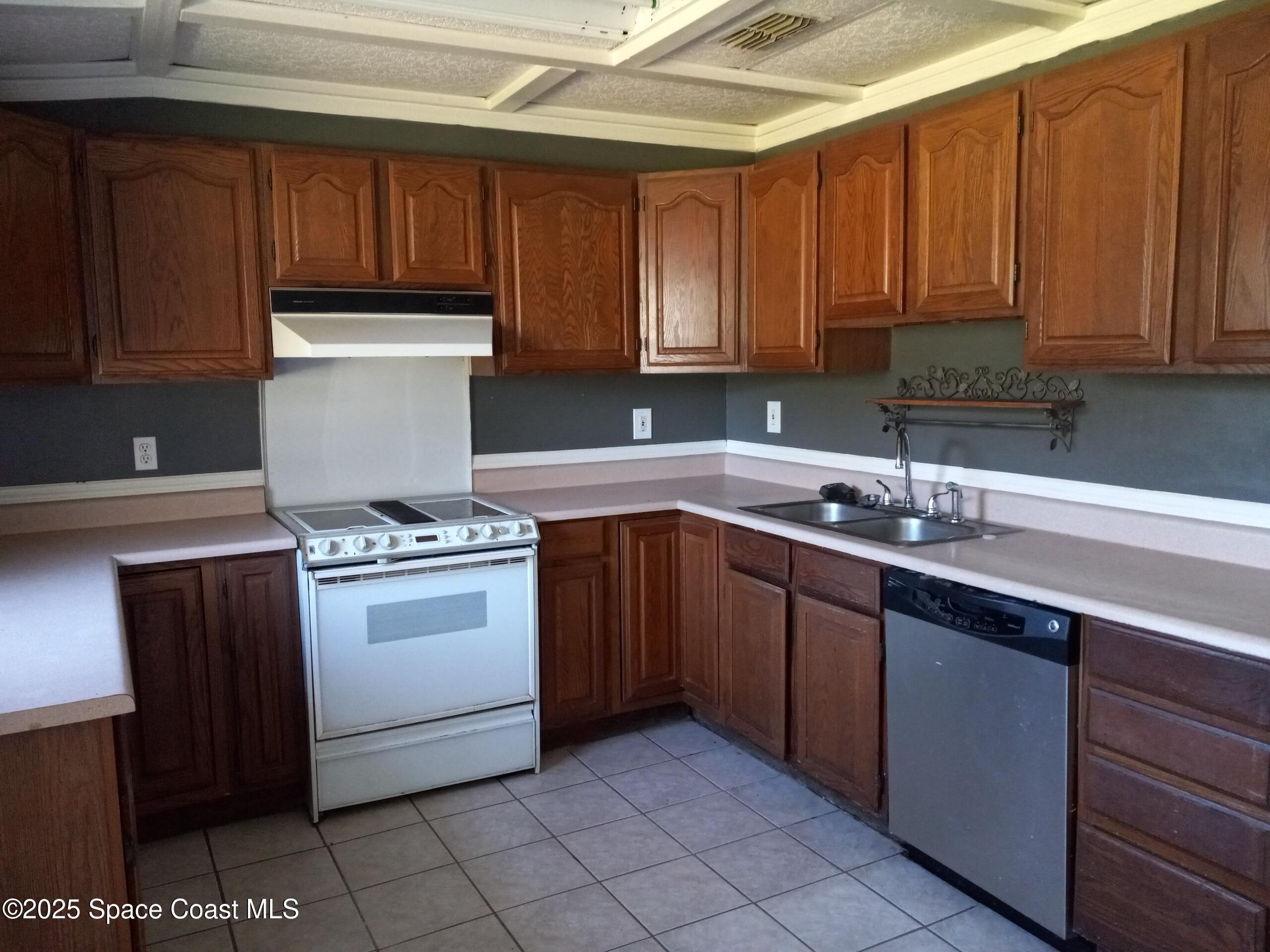 4335 Kumquat Street Cocoa, FL 32926 - Photo 10 of 21 a kitchen with a sink a stove and cabinets