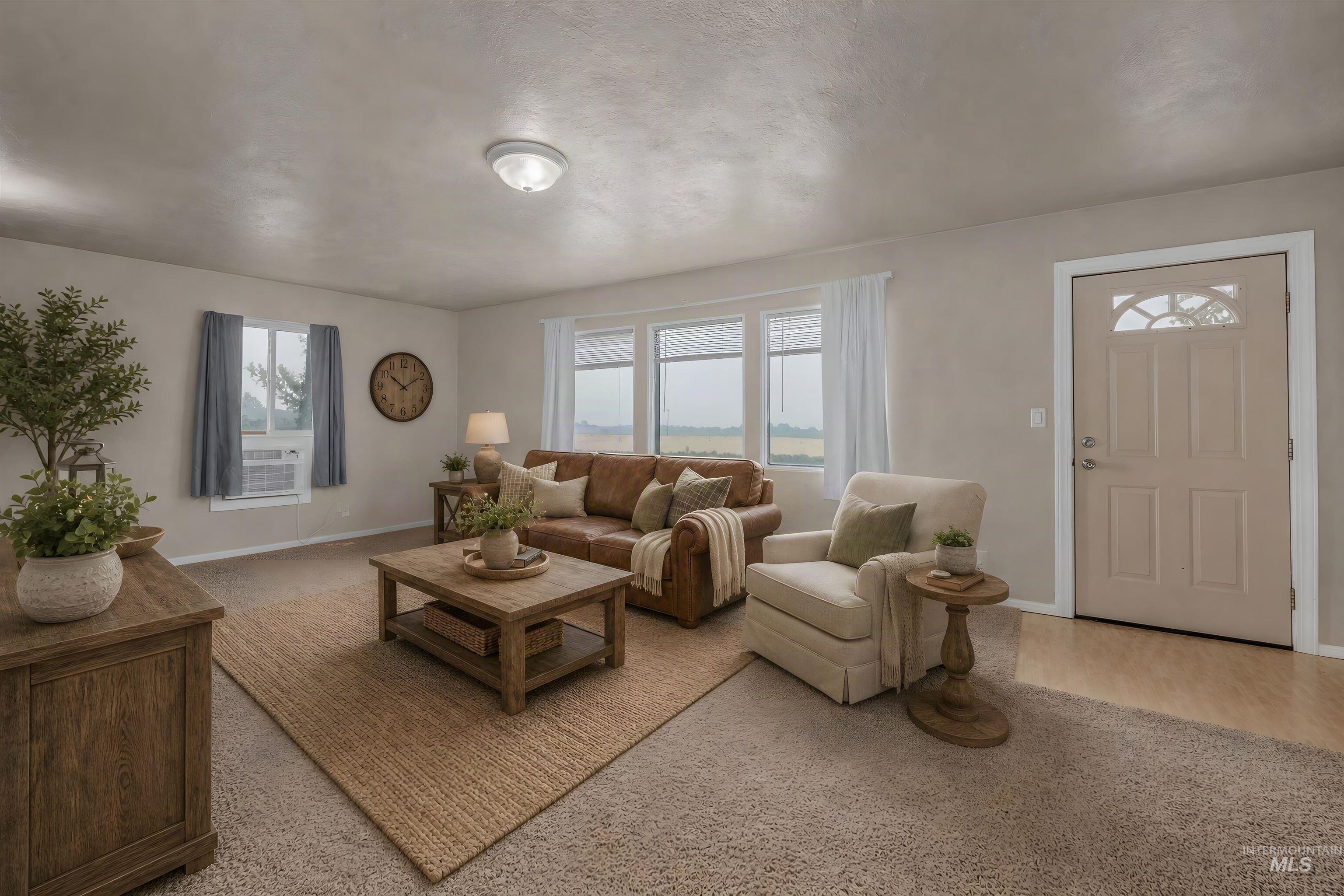1741 Cove Road Weiser, ID 83672 - Photo 5 of 46 Living area featuring light-toned walls, neutral carpeting, and a contrasting area rug