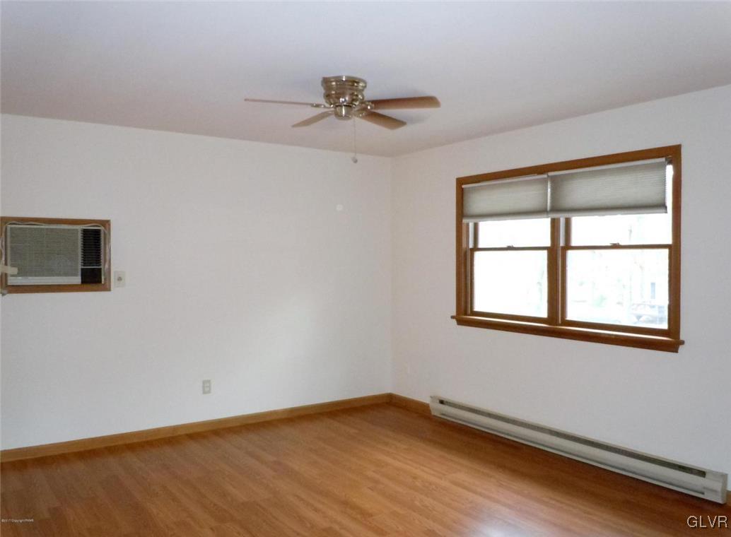 1136 Mattioli Road Bartonsville, PA 18321 - Photo 7 of 30 a view of an empty room with wooden floor and a window