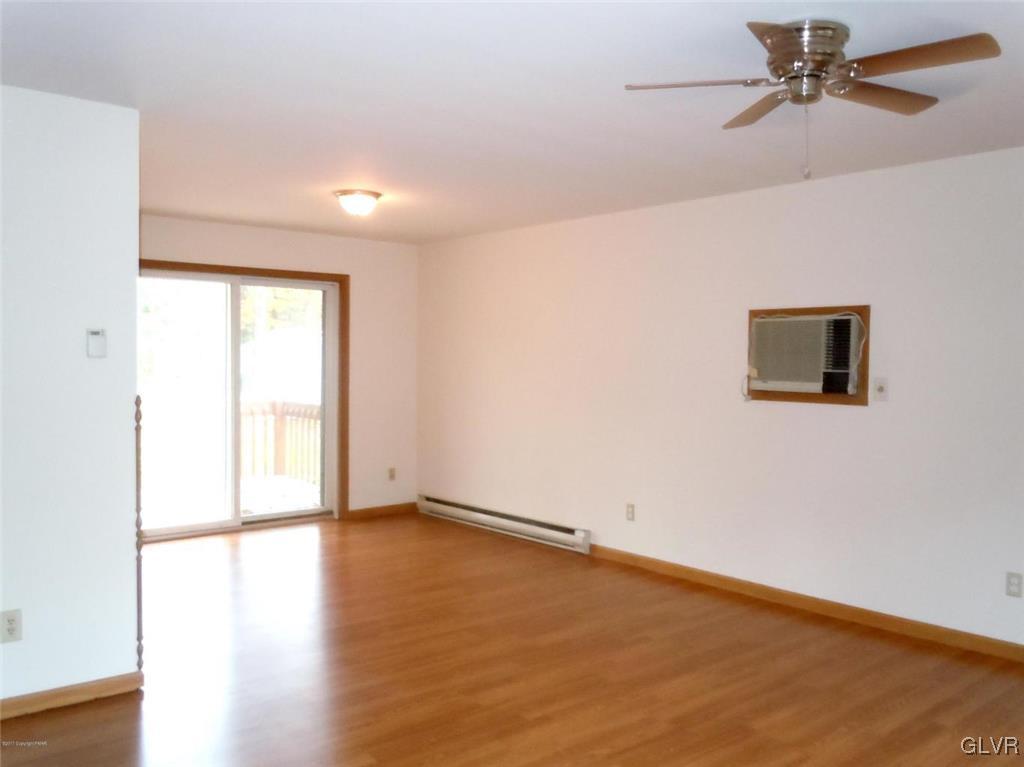 1136 Mattioli Road Bartonsville, PA 18321 - Photo 8 of 30 a view of a room with wooden floor and a ceiling fan