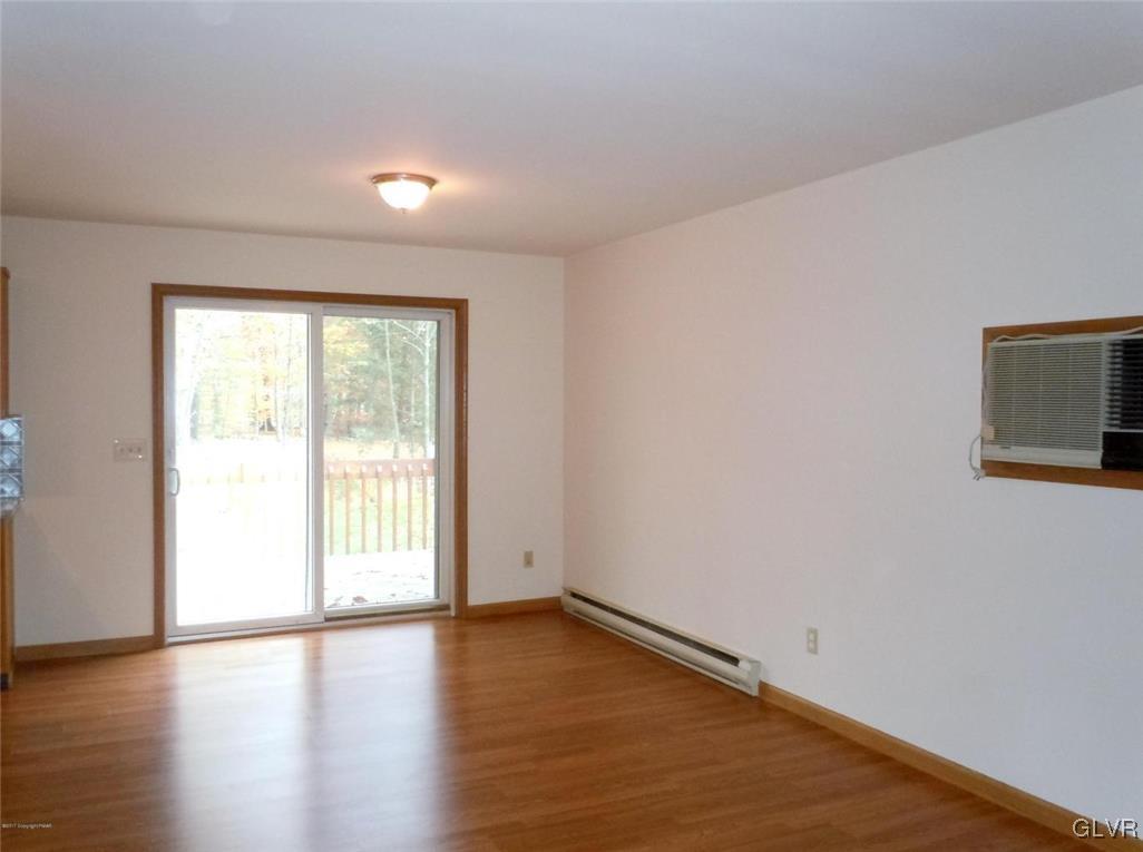 1136 Mattioli Road Bartonsville, PA 18321 - Photo 9 of 30 a view of an empty room with wooden floor and a window