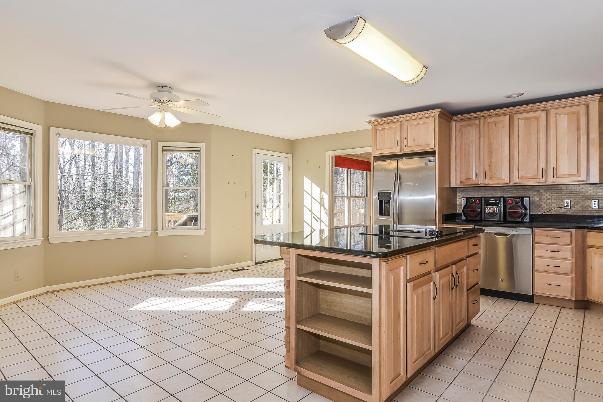 8670 Center Road Springfield, VA 22152 - Photo 11 of 33 Breakfast bar island w/ shelving, tile backsplash