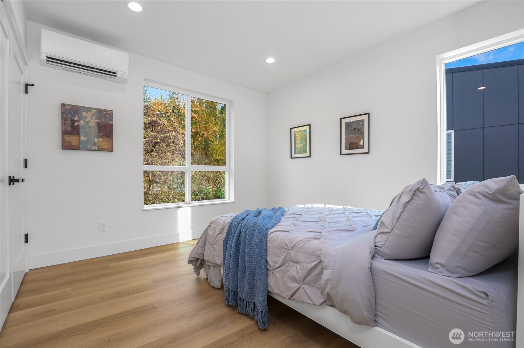 10626 East Riverside Drive Bothell, WA 98011 - Photo 23 of 30 a bed sitting in a bedroom next to a window