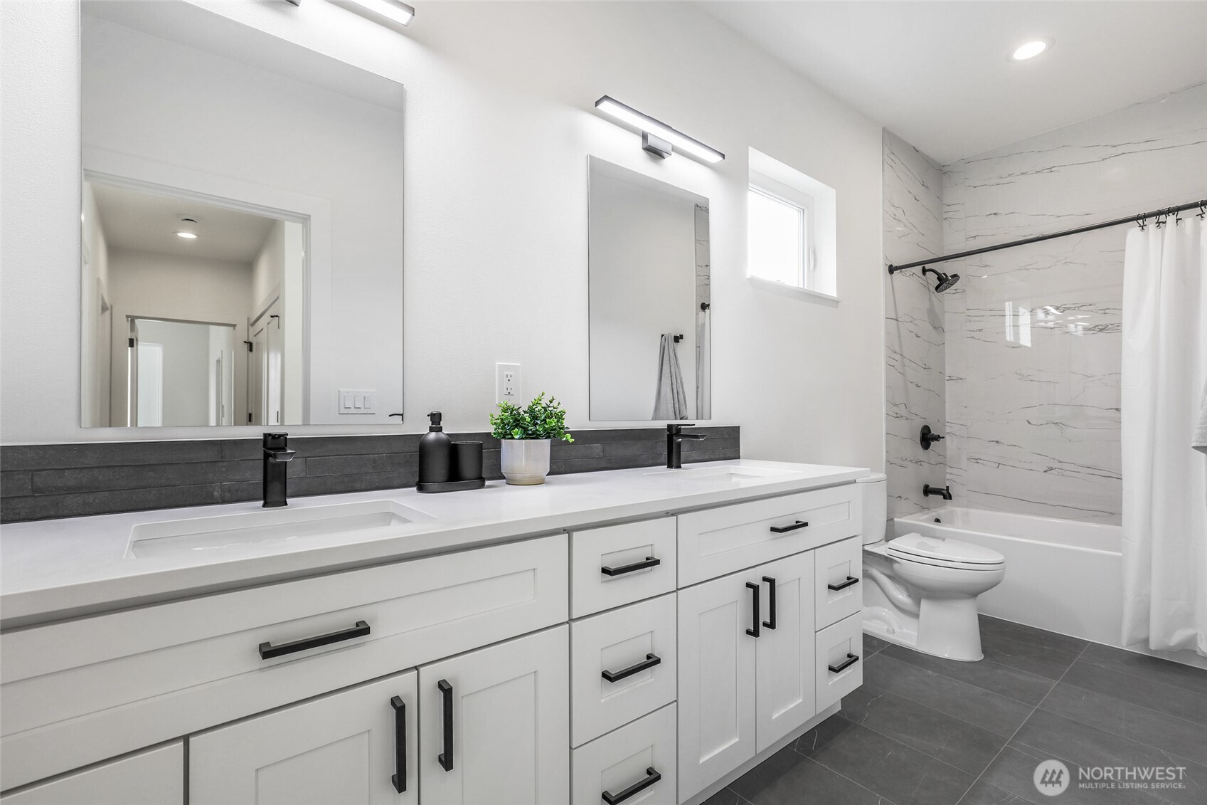 10626 East Riverside Drive Bothell, WA 98011 - Photo 24 of 30 a bathroom with double sink a toilet a shower and a mirror