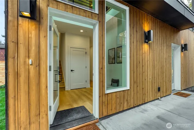 a view of entryway and hall with wooden floor