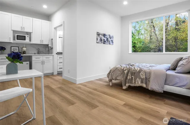 a kitchen with white cabinets and sink