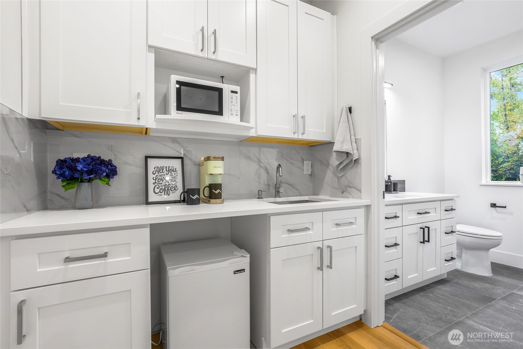 10626 East Riverside Drive Bothell, WA 98011 - Photo 7 of 30 a kitchen with white cabinets and sink