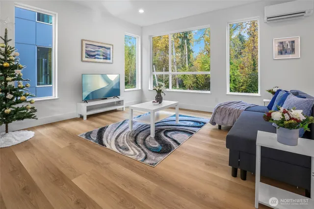 a living room with furniture and a wooden floor