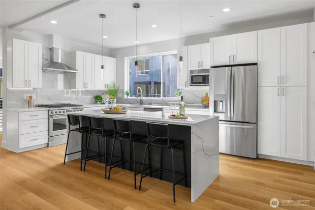 a kitchen with a sink and chairs