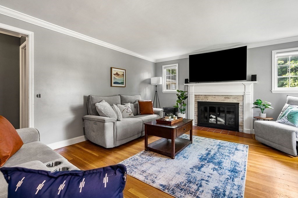 70 Indian Hill Road Worcester, MA 01606 - Photo 4 of 34 a living room with furniture a flat screen tv and a fireplace