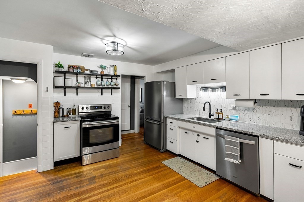 70 Indian Hill Road Worcester, MA 01606 - Photo 8 of 34 a kitchen with stainless steel appliances granite countertop a refrigerator a stove a sink and a refrigerator