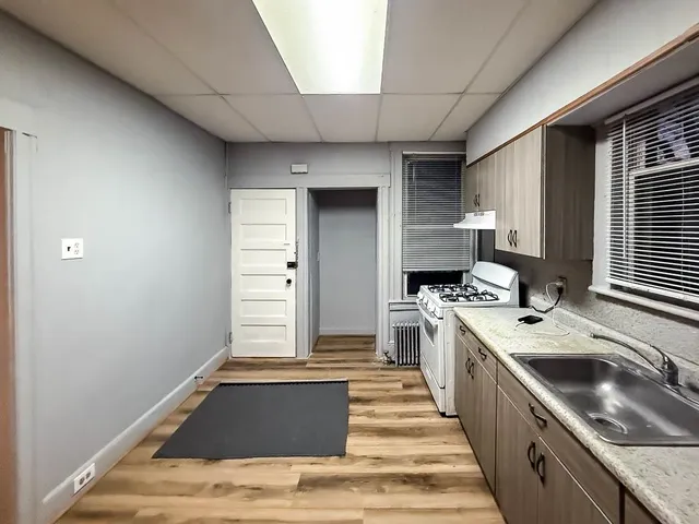 a kitchen with a sink cabinets and window