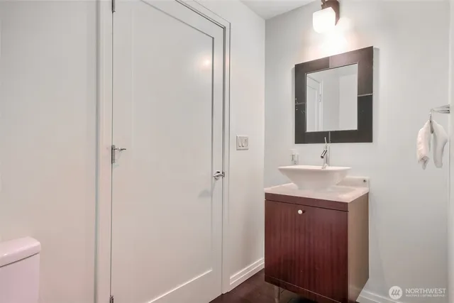 a bathroom with a sink a toilet and mirror