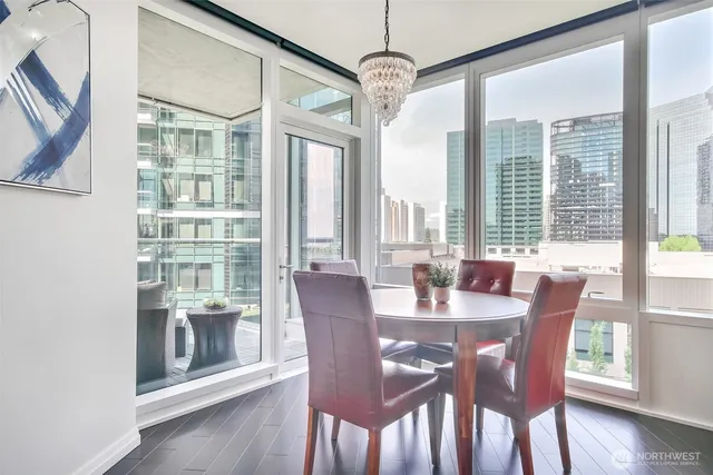 a view of a dining room with furniture wooden floor and chandelier