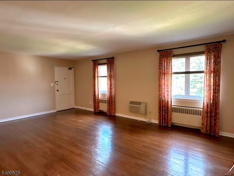 12 Troy Drive, Unit B Springfield, NJ 07081 - Photo 1 of 6 an empty room with wooden floor and windows