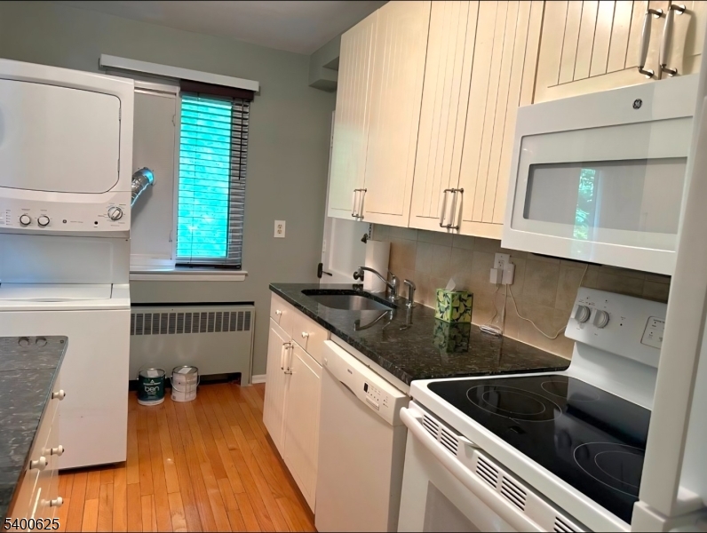 12 Troy Drive, Unit B Springfield, NJ 07081 - Photo 3 of 6 a kitchen with a sink a stove and cabinets