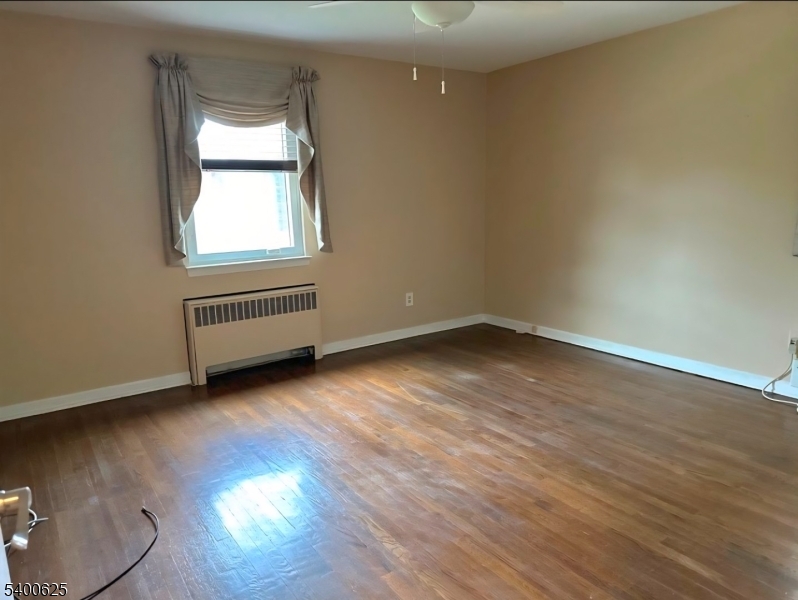 12 Troy Drive, Unit B Springfield, NJ 07081 - Photo 4 of 6 an empty room with wooden floor and windows