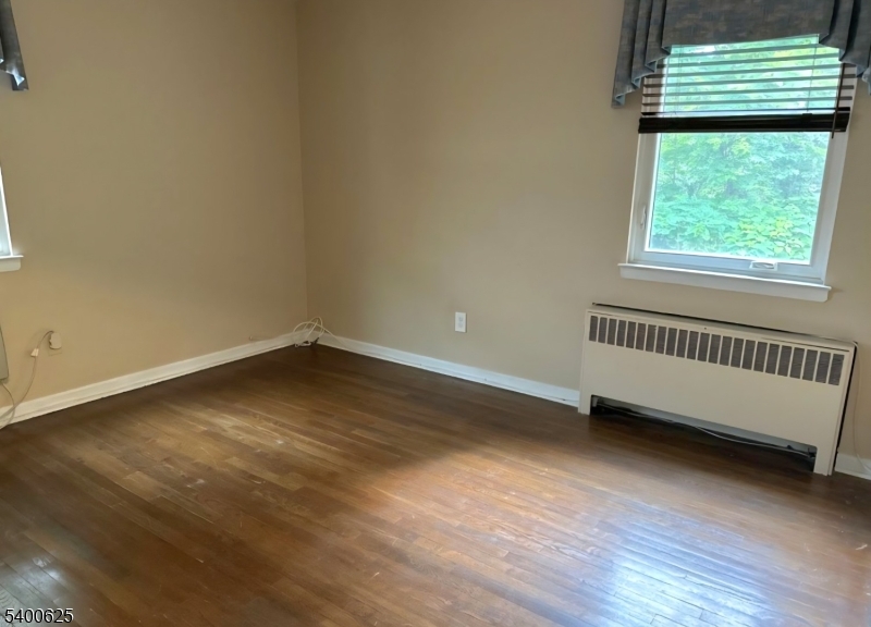 12 Troy Drive, Unit B Springfield, NJ 07081 - Photo 5 of 6 an empty room with wooden floor and windows