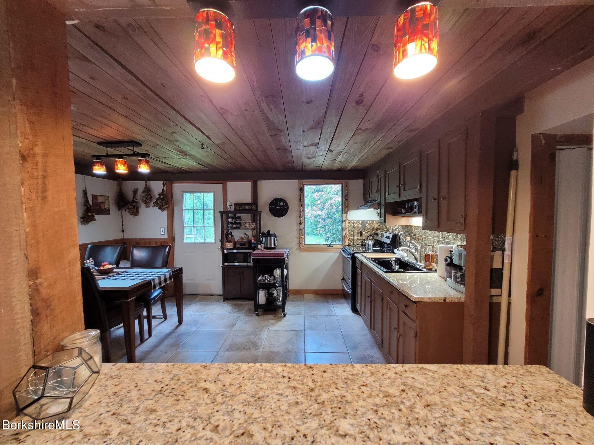 106 Access Road Becket, MA 01223 - Photo 13 of 43 a kitchen with stainless steel appliances granite countertop lots of counter top space