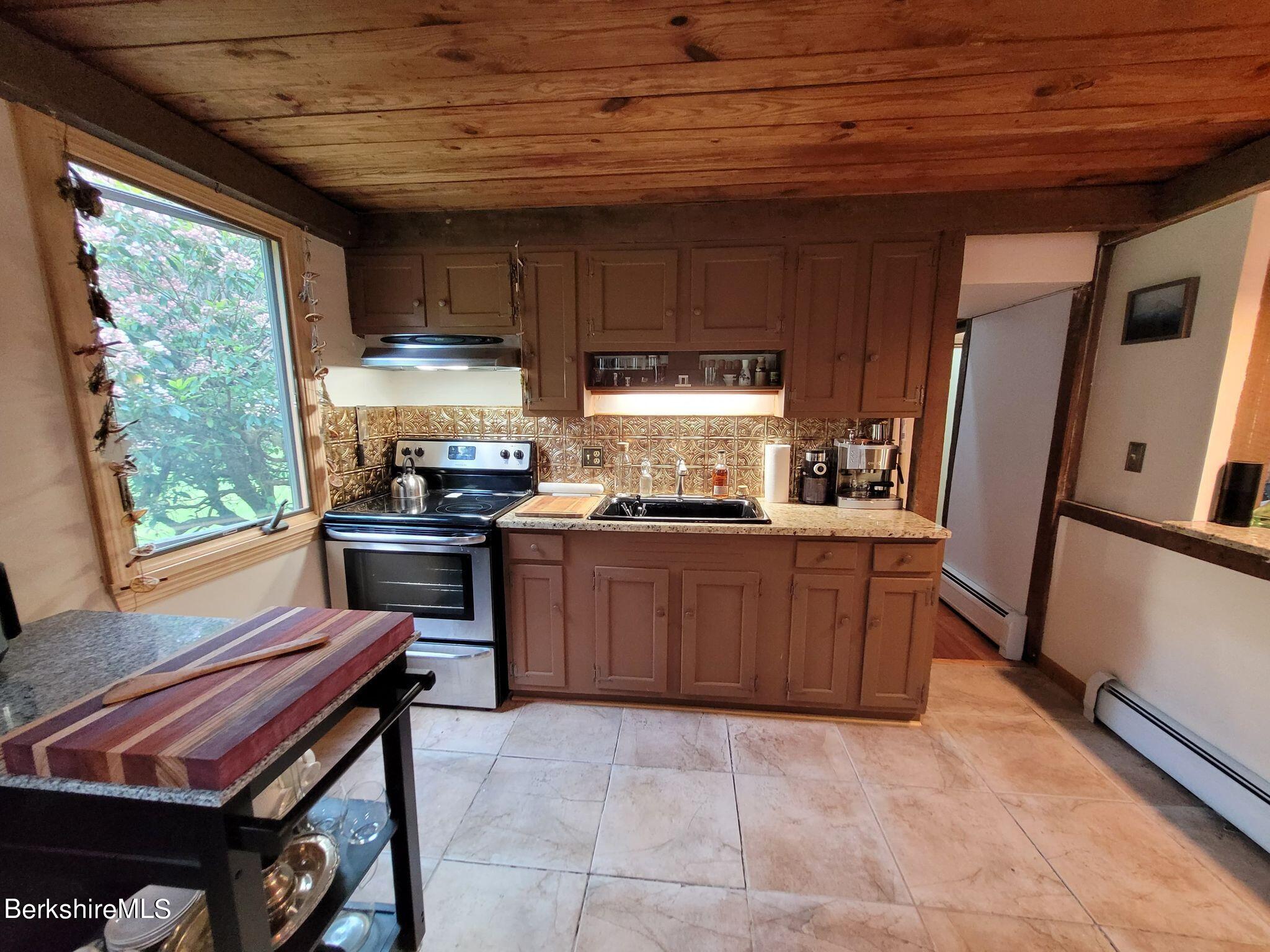 106 Access Road Becket, MA 01223 - Photo 15 of 43 a kitchen with a sink appliances and cabinets