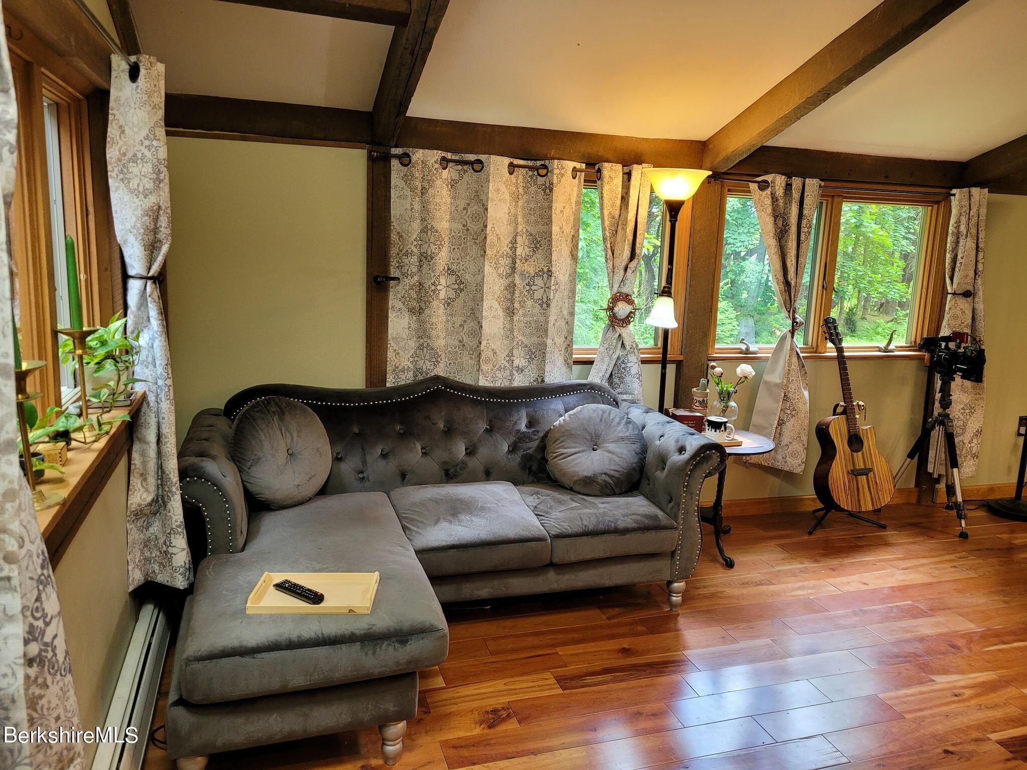 106 Access Road Becket, MA 01223 - Photo 19 of 43 a living room with furniture and a floor to ceiling window