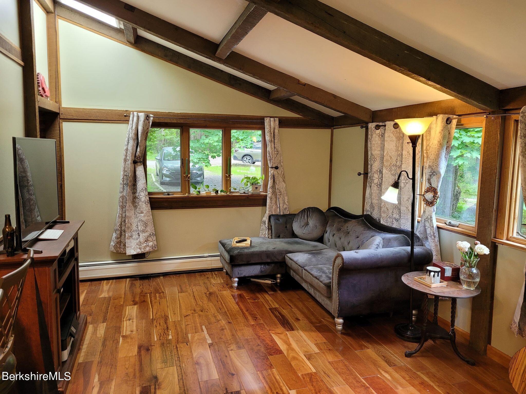 106 Access Road Becket, MA 01223 - Photo 20 of 43 a living room with furniture and a flat screen tv