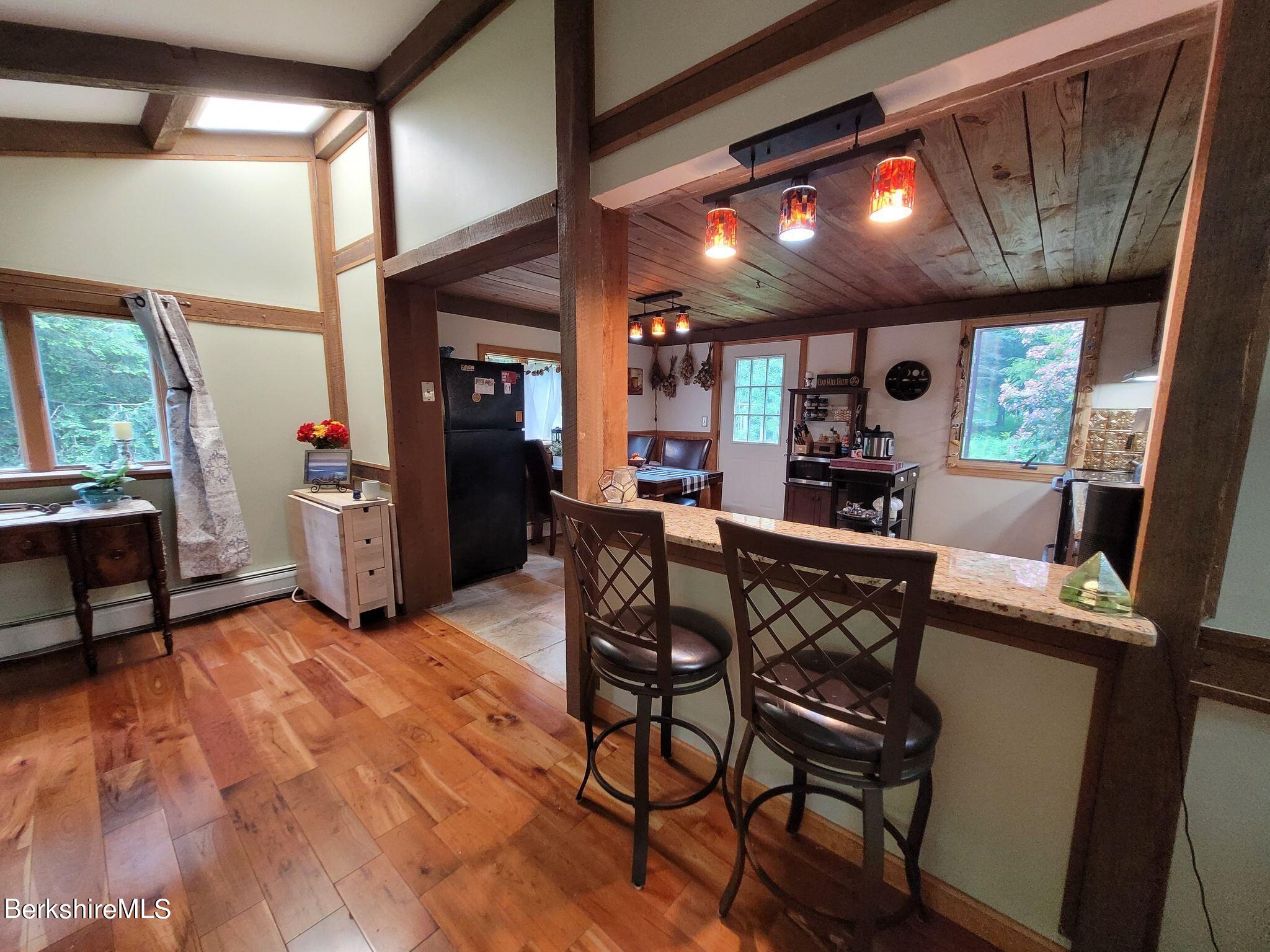 106 Access Road Becket, MA 01223 - Photo 22 of 43 a view of a dining room with furniture window and wooden floor