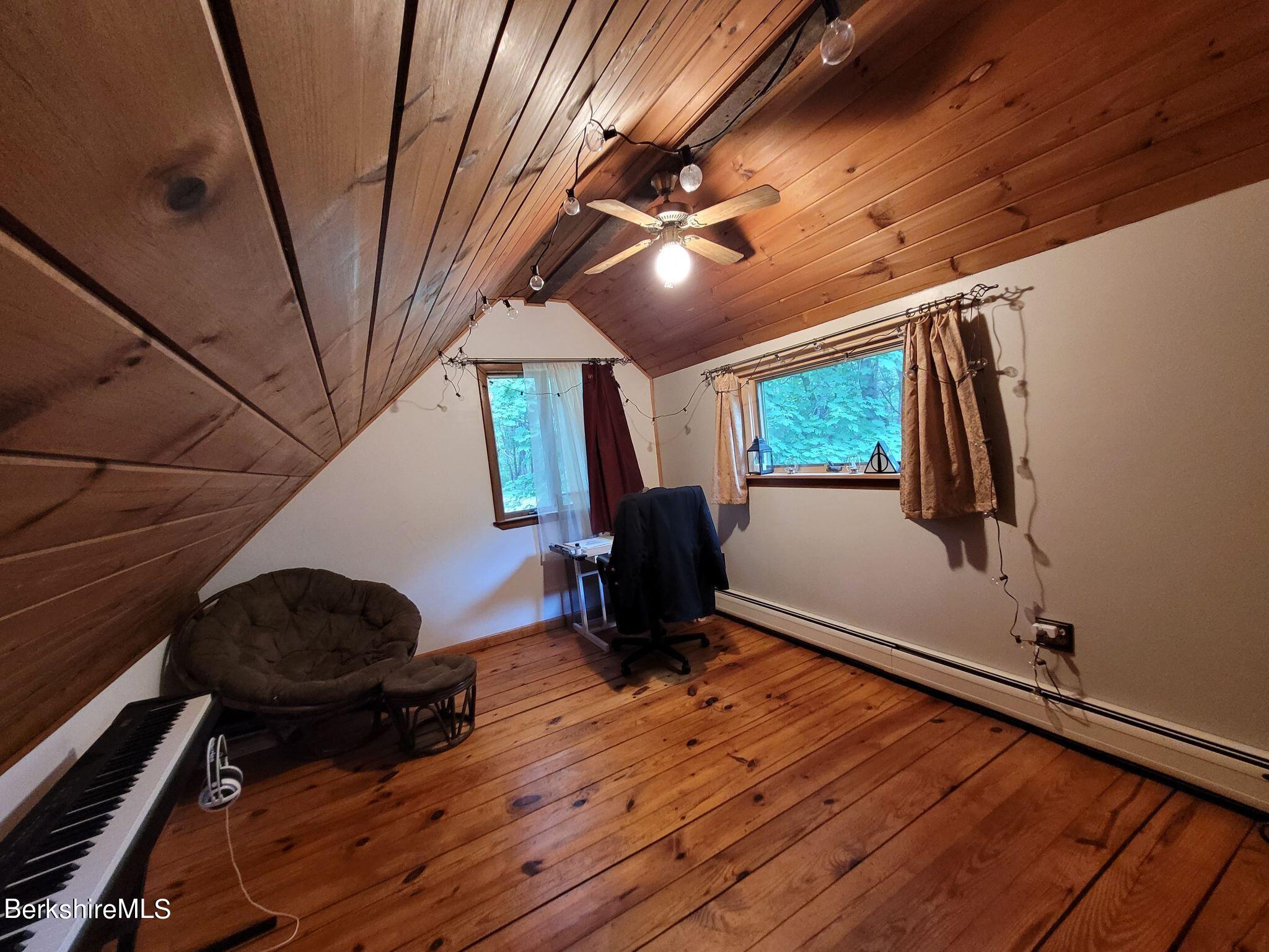 106 Access Road Becket, MA 01223 - Photo 27 of 43 a room with wooden floor and furniture