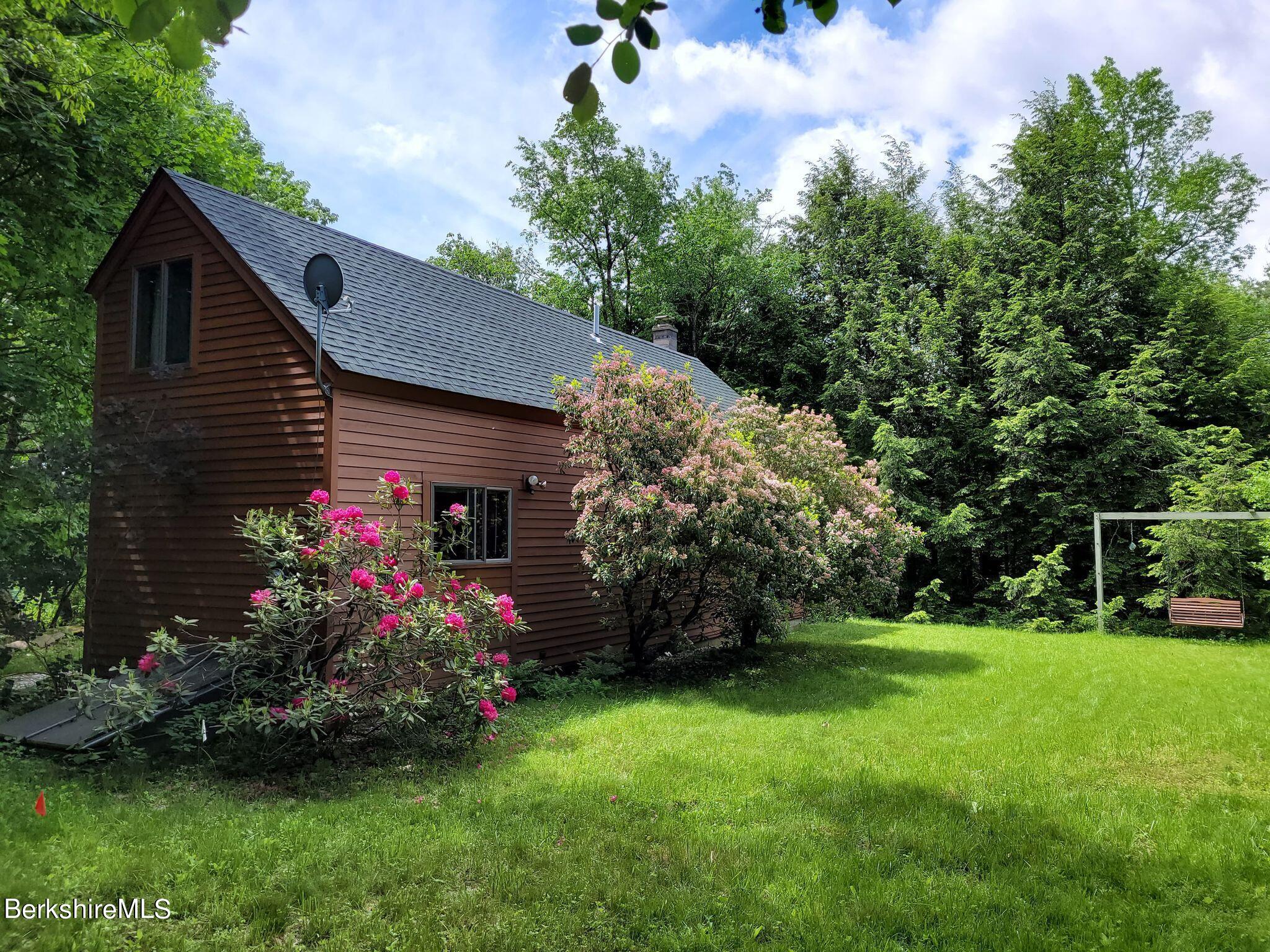 106 Access Road Becket, MA 01223 - Photo 35 of 43 a front view of house with garden