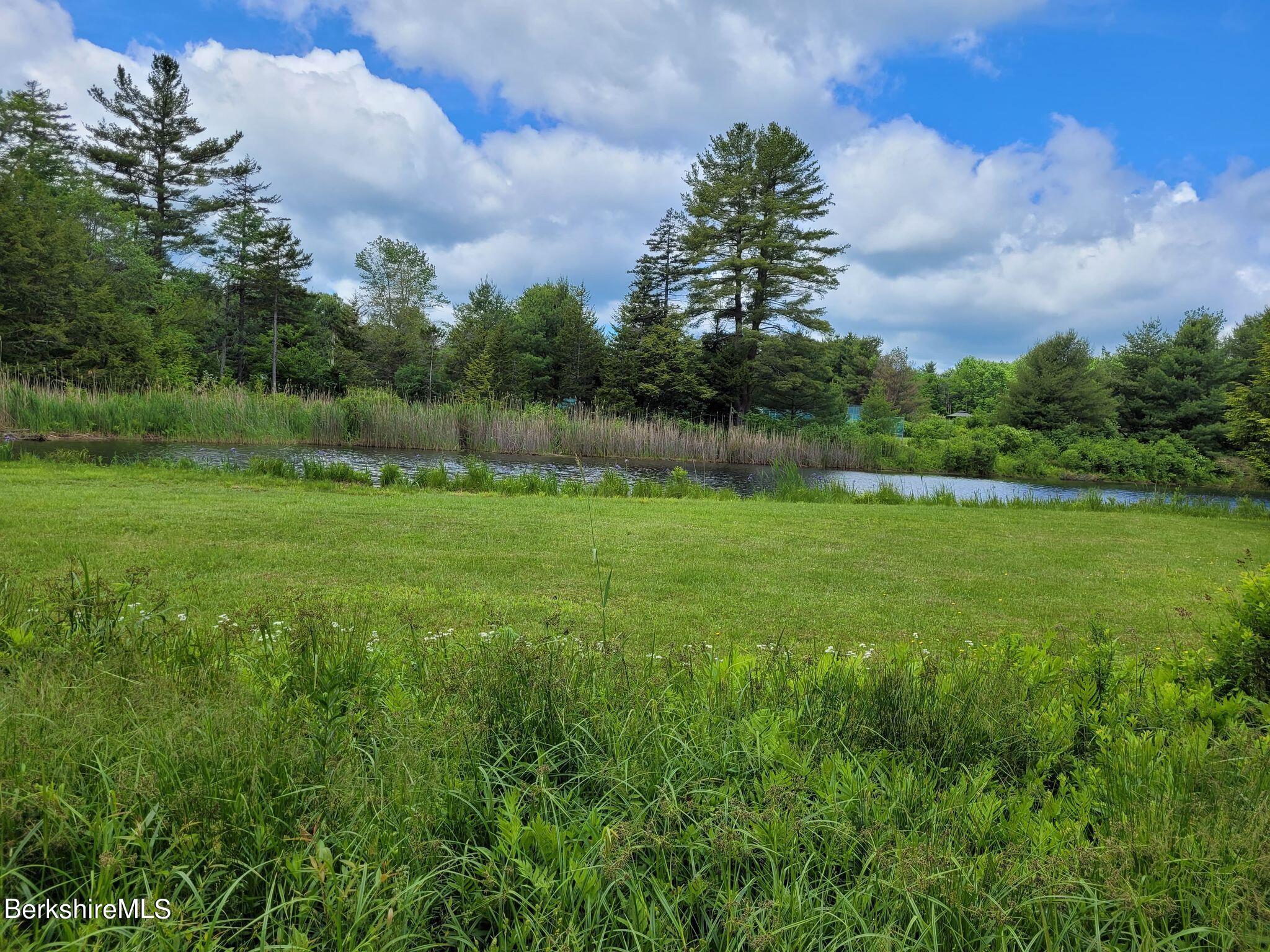 106 Access Road Becket, MA 01223 - Photo 39 of 43 a view of a garden with a lake