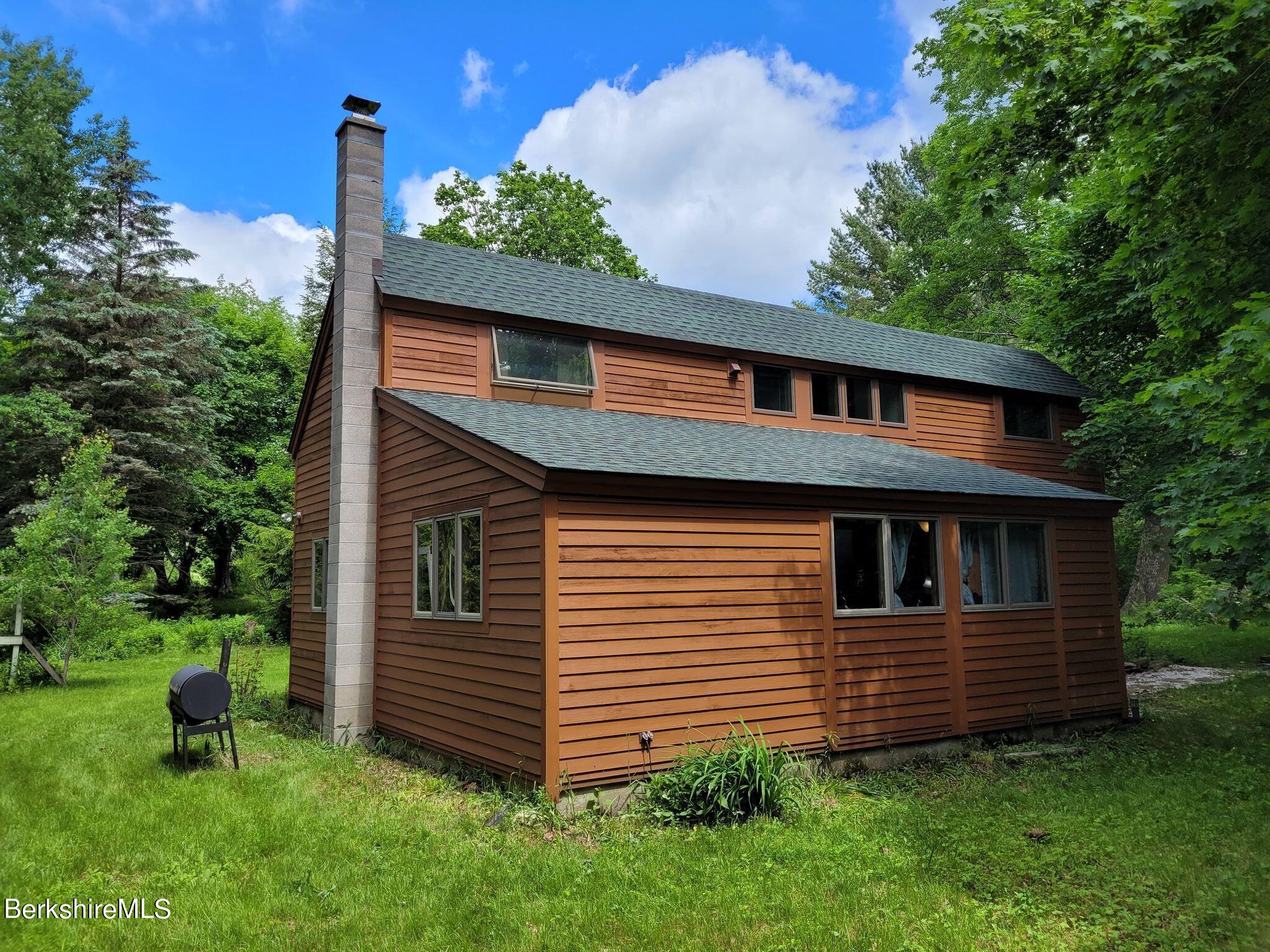 106 Access Road Becket, MA 01223 - Photo 6 of 43 a view of a house with a yard