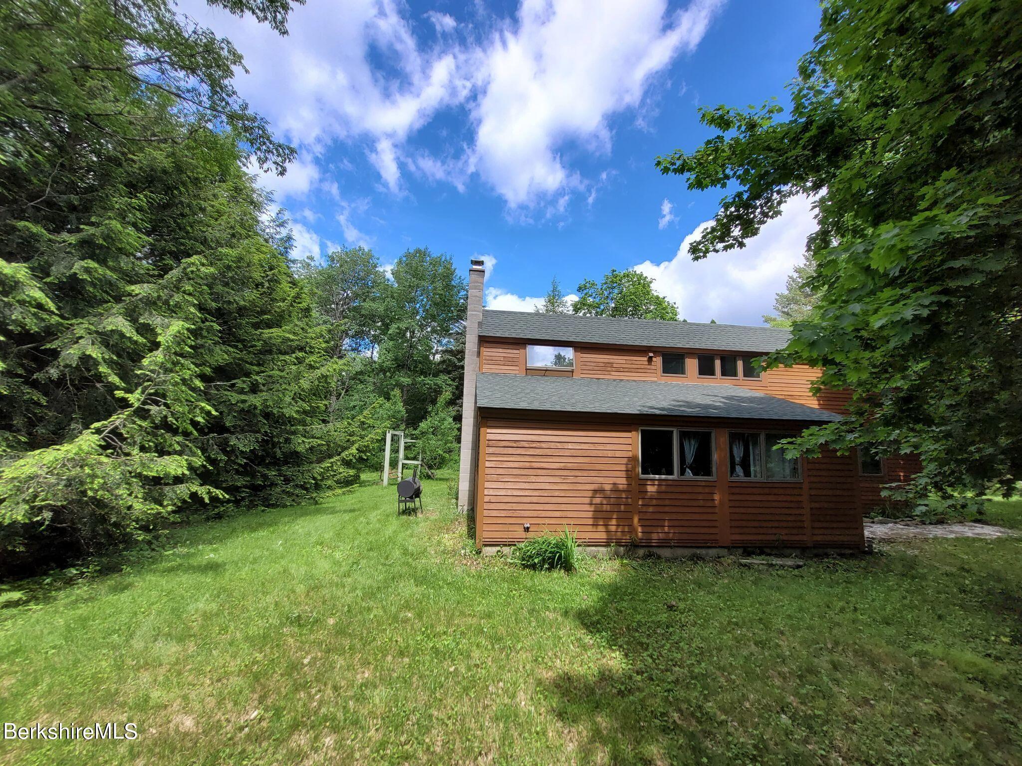 106 Access Road Becket, MA 01223 - Photo 8 of 43 a view of a house with a backyard