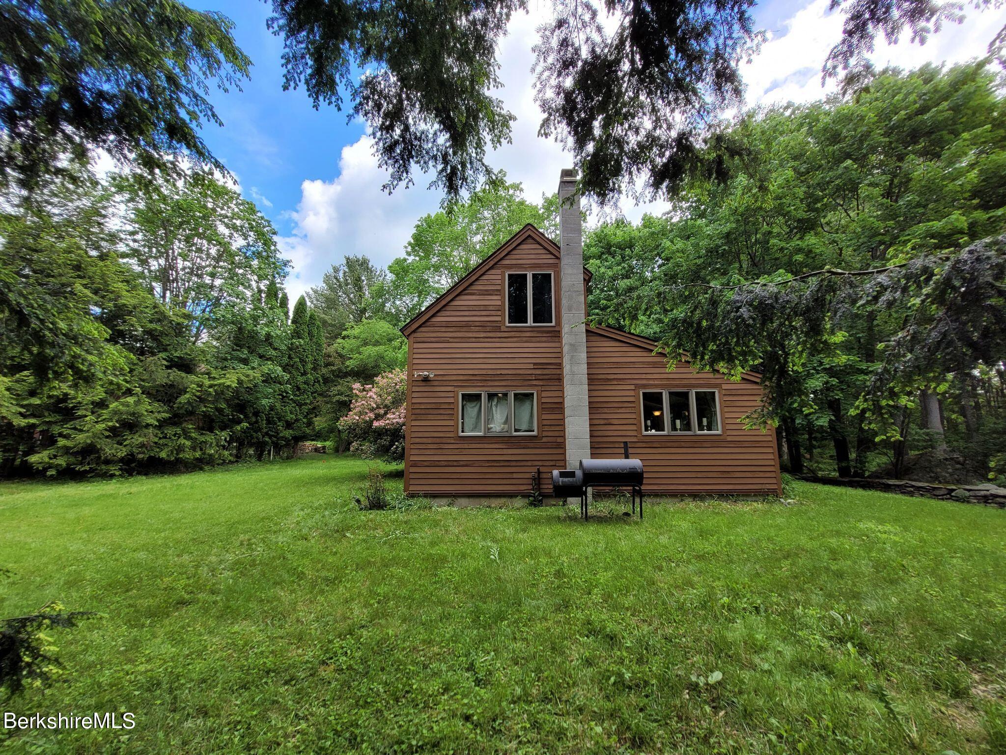 106 Access Road Becket, MA 01223 - Photo 9 of 43 a view of a house with a yard