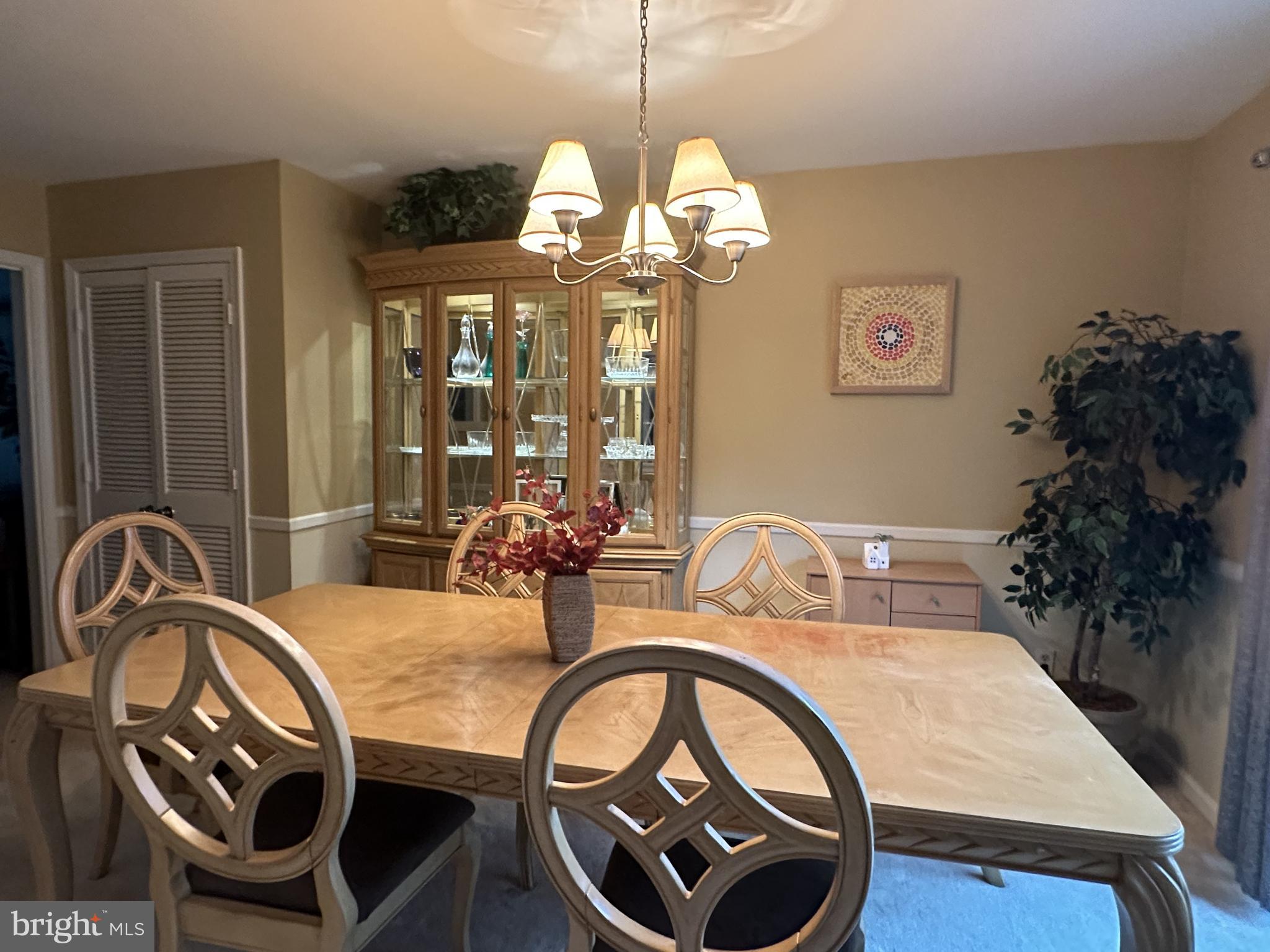8244 Carrleigh Parkway Springfield, VA 22152 - Photo 9 of 25 a view of a dining room with furniture and chandelier
