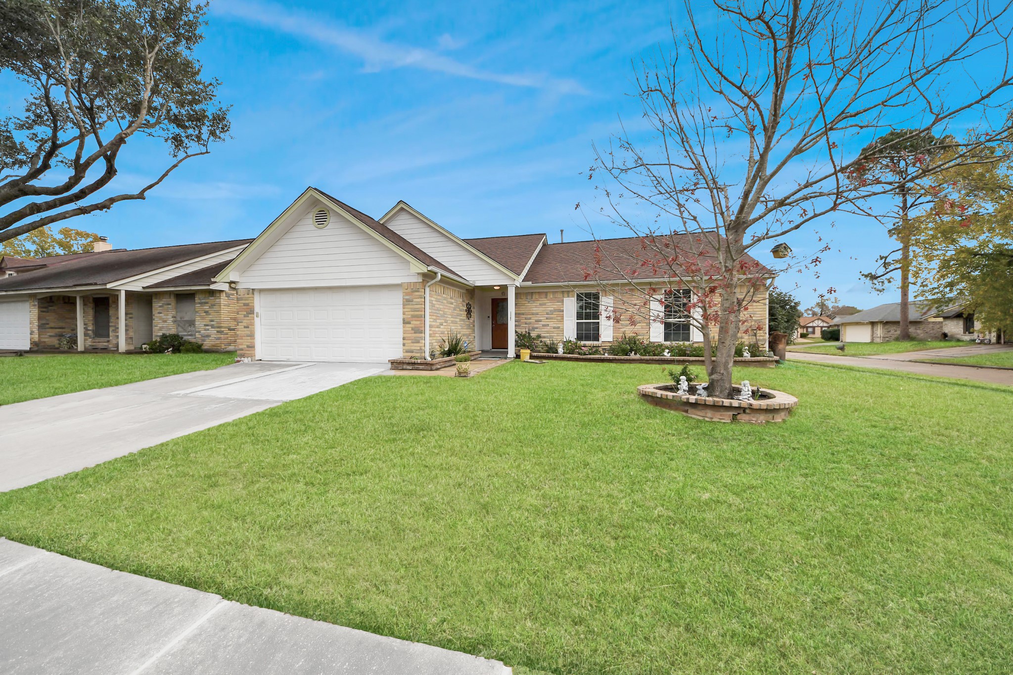 17702 Poppy Trails Lane Houston, TX 77084 - Photo 2 of 37 This home greets you with standout curb appeal, featuring a timeless brick elevation, neatly manicured landscaping, and a lush front lawn accented by graceful, maturing trees.