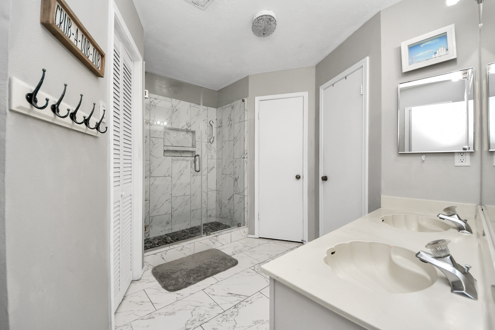17702 Poppy Trails Lane Houston, TX 77084 - Photo 24 of 37 The renovated shower is the standpoint of this bathroom, and the dual sinks will give you space and comfort.