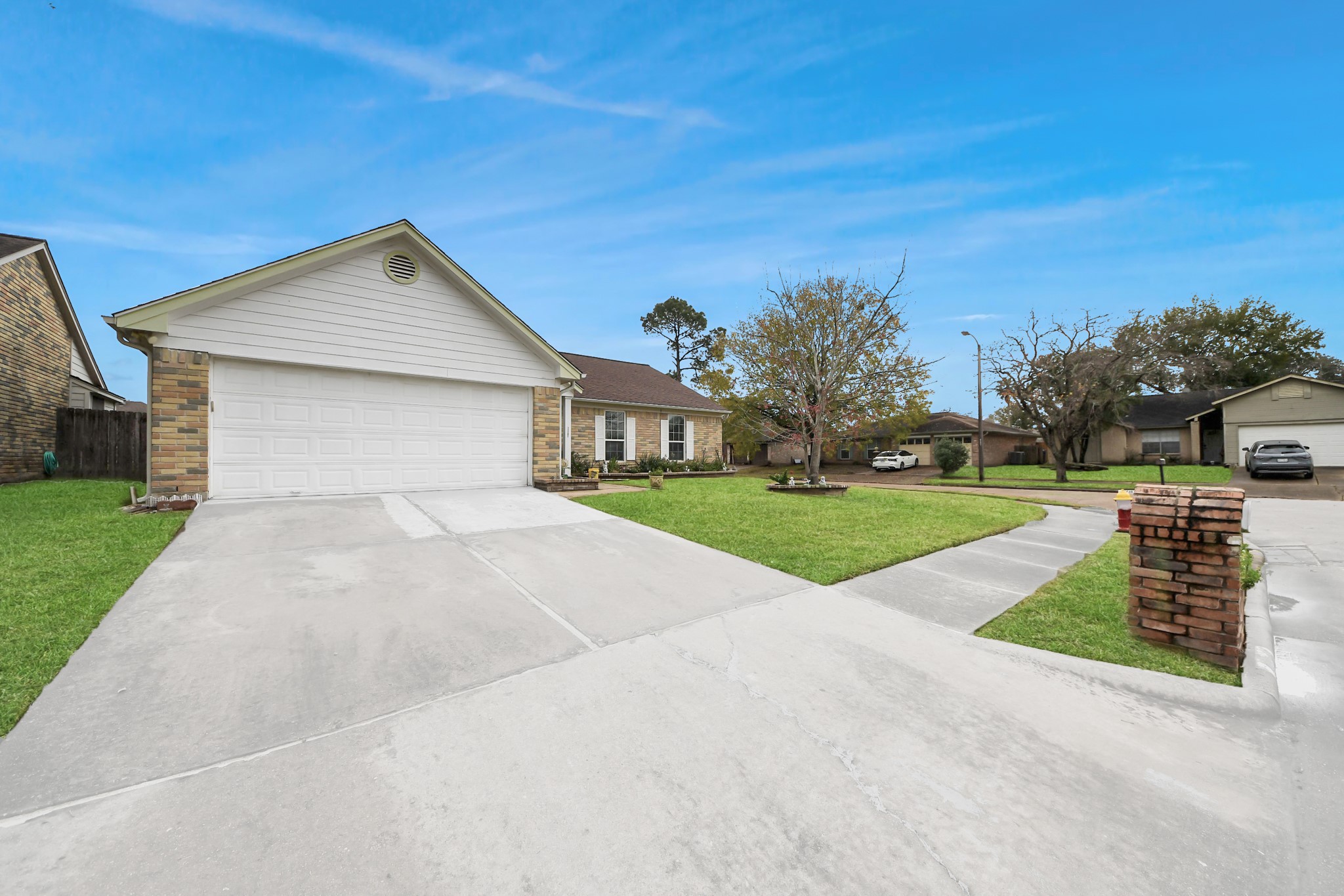 17702 Poppy Trails Lane Houston, TX 77084 - Photo 5 of 37 This home has beautiful curb appeal including classic brick elevation, manicured landscape, and a green front lawn with maturing trees.