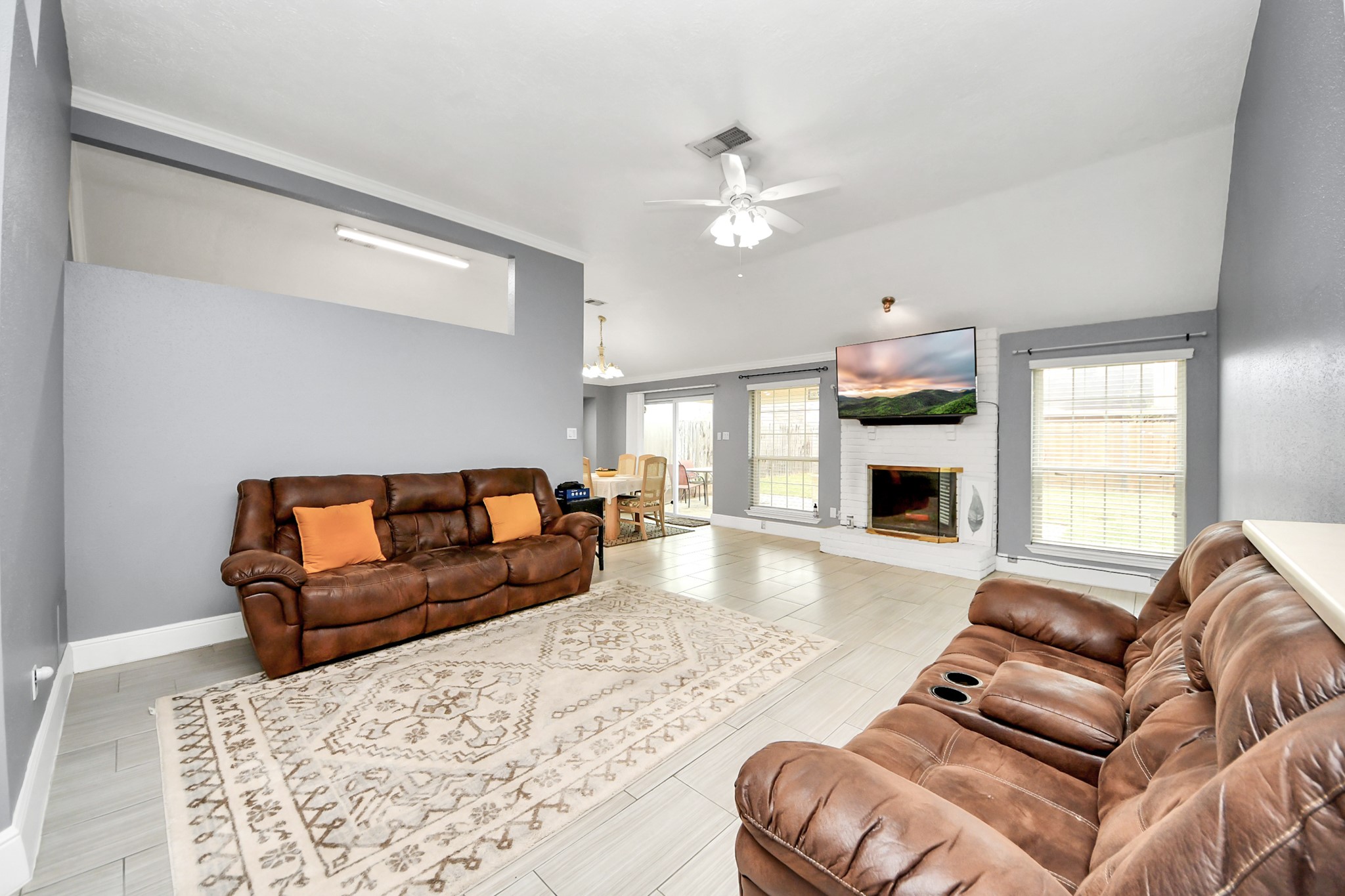 17702 Poppy Trails Lane Houston, TX 77084 - Photo 7 of 37 The spacious family room offers several standout features, including a ceiling fan, a cozy fireplace, and a seamless connection to the rest of the home.