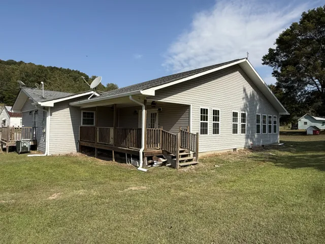 a view of a house with a large window and a yard