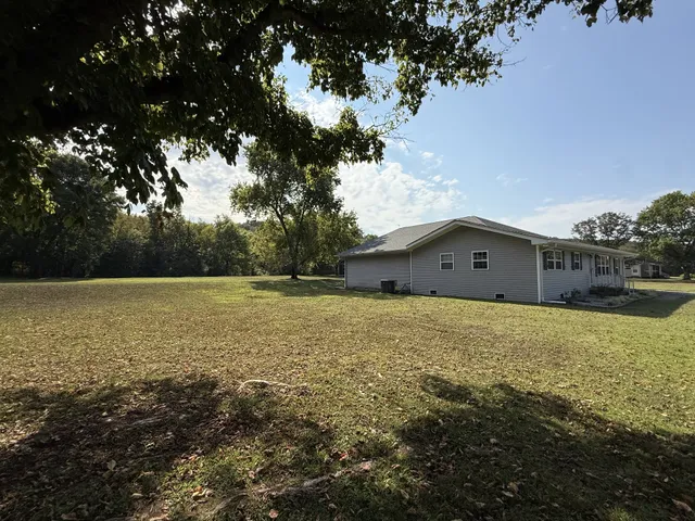 a backyard of a house with lots of green space