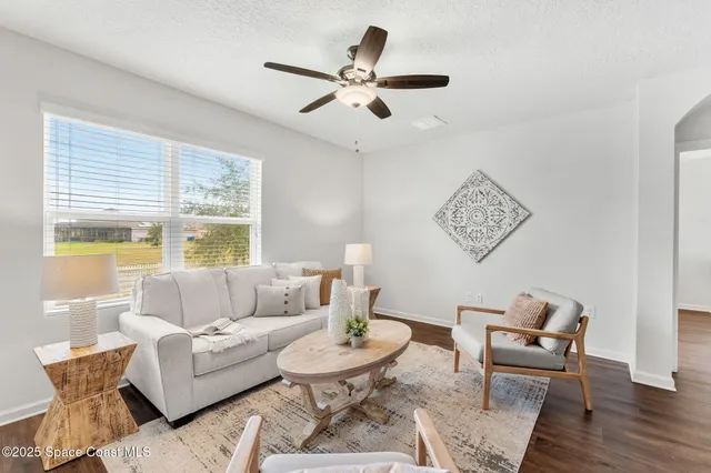 a living room with furniture and a large window