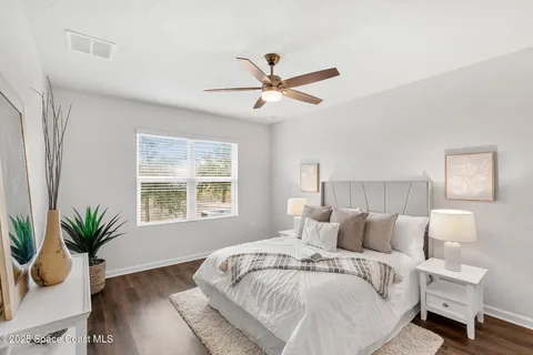 a spacious bedroom with a bed and a window