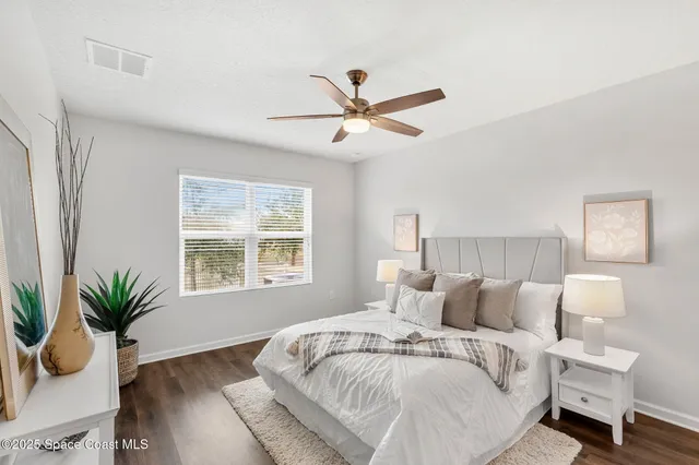 a spacious bedroom with a bed and a window