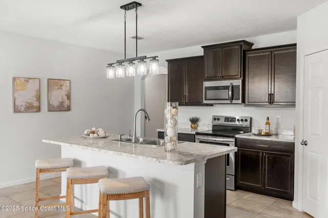 a kitchen with stainless steel appliances a sink stove and microwave