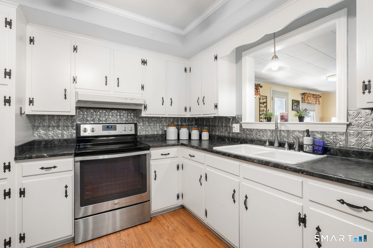 9 Stanton Road North Haven, CT 06473 - Photo 6 of 35 a kitchen with granite countertop white cabinets and white appliances