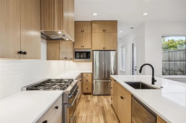 a white stove top oven sitting inside of a kitchen