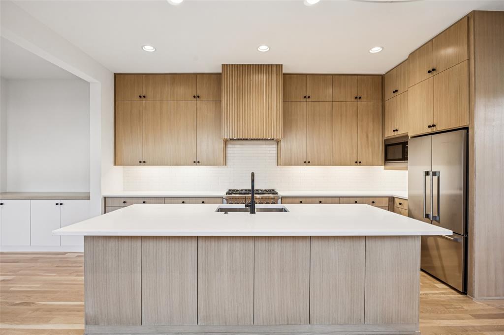 5600 Ellsworth Avenue Dallas, TX 75206 - Photo 17 of 31 a kitchen with a sink a refrigerator and a stove