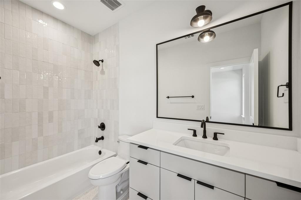 5600 Ellsworth Avenue Dallas, TX 75206 - Photo 26 of 31 a bathroom with a sink a toilet and shower